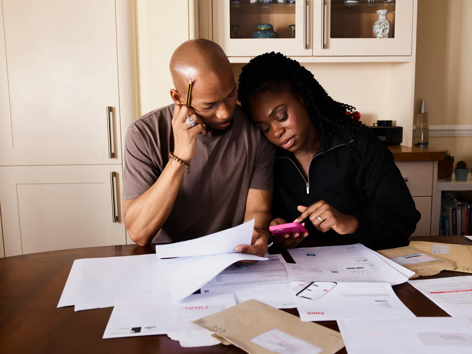 Couple reviewing mortgage documents at a kitchen table