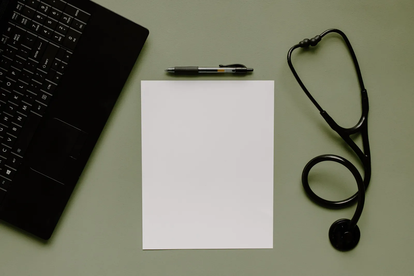 Stethoscope, calculator, and paperwork on a desk representing health insurance planning