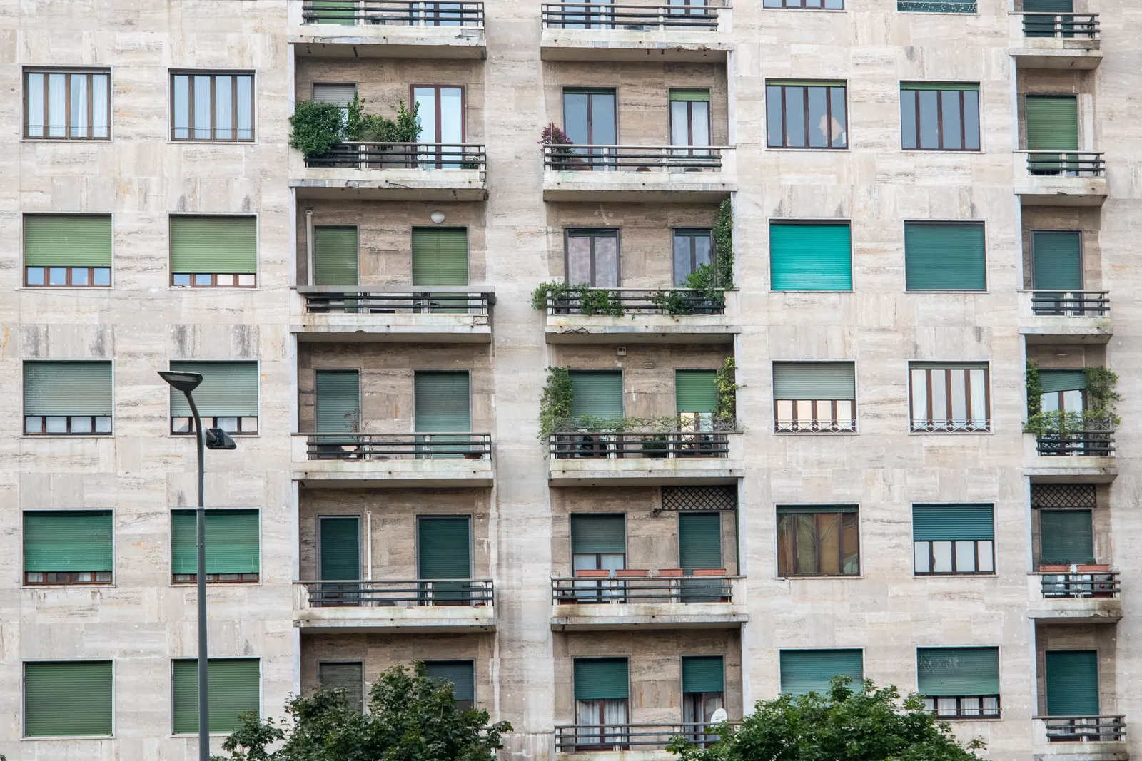 Urban mid-rise condominium building with rows of windows and balconies