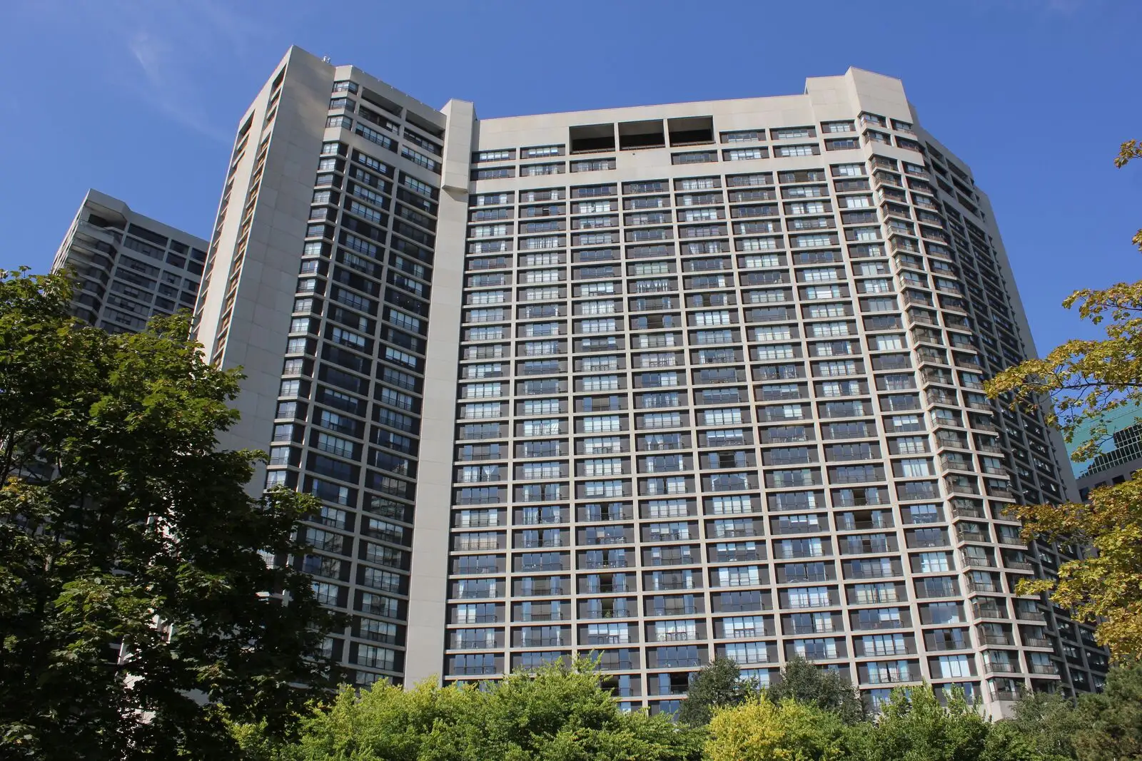 Modern high-rise residential building against a clear sky