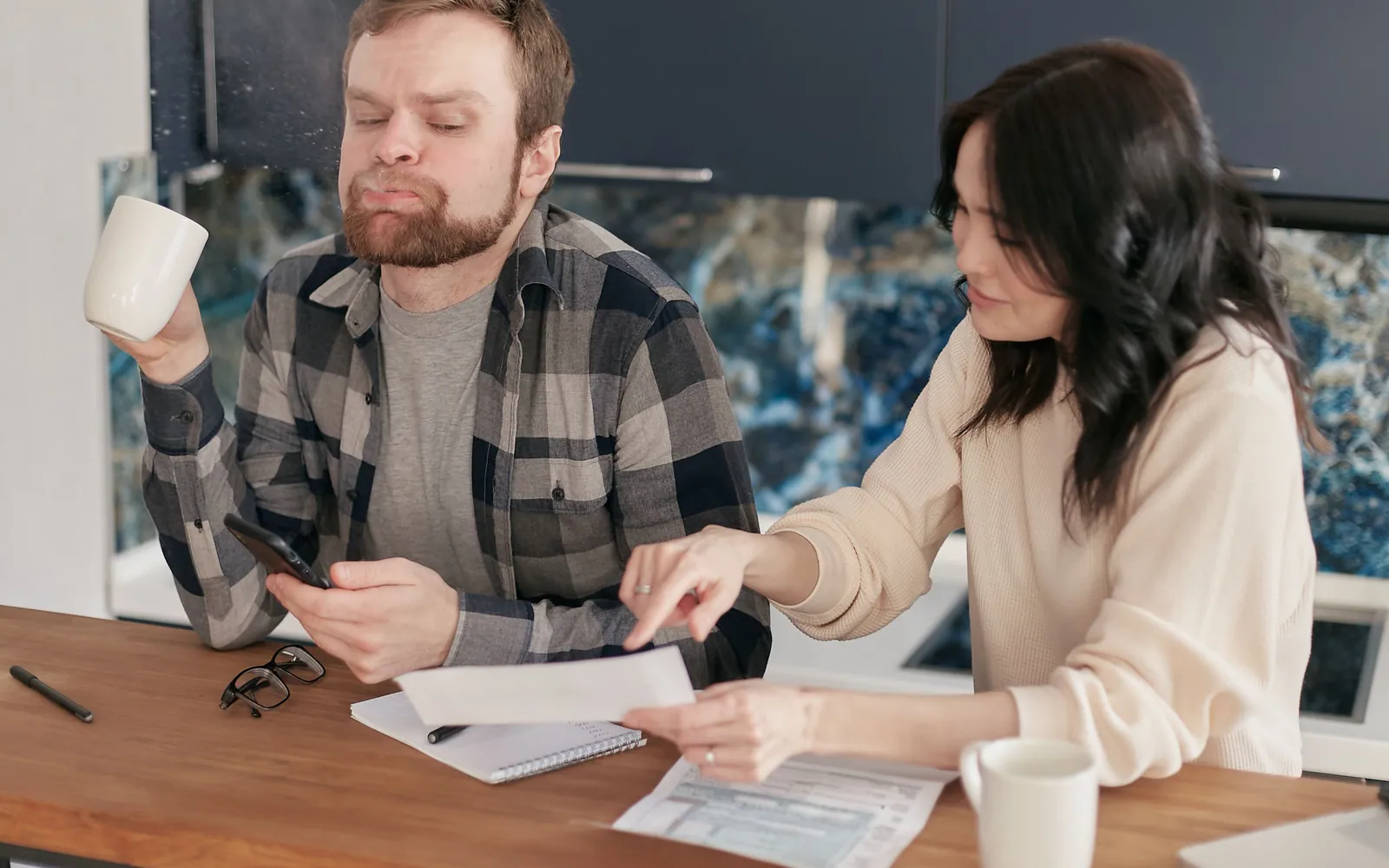 Family reviewing mortgage documents at the kitchen table