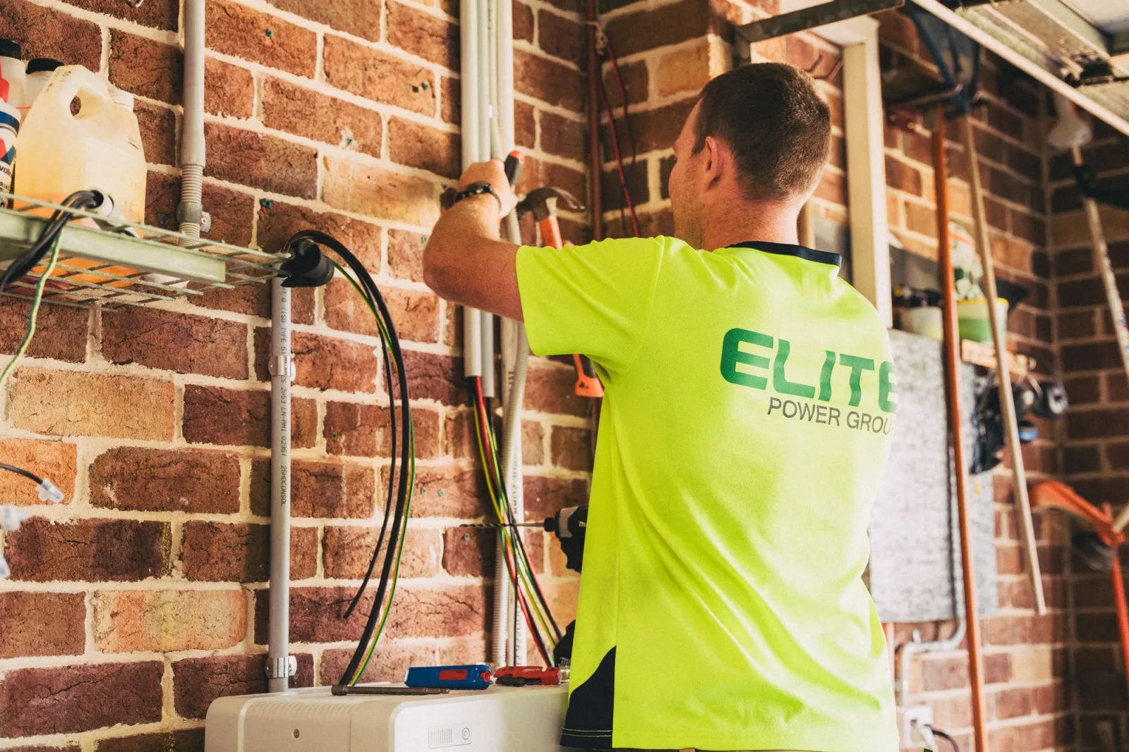 An electrician working on a home solar battery installation