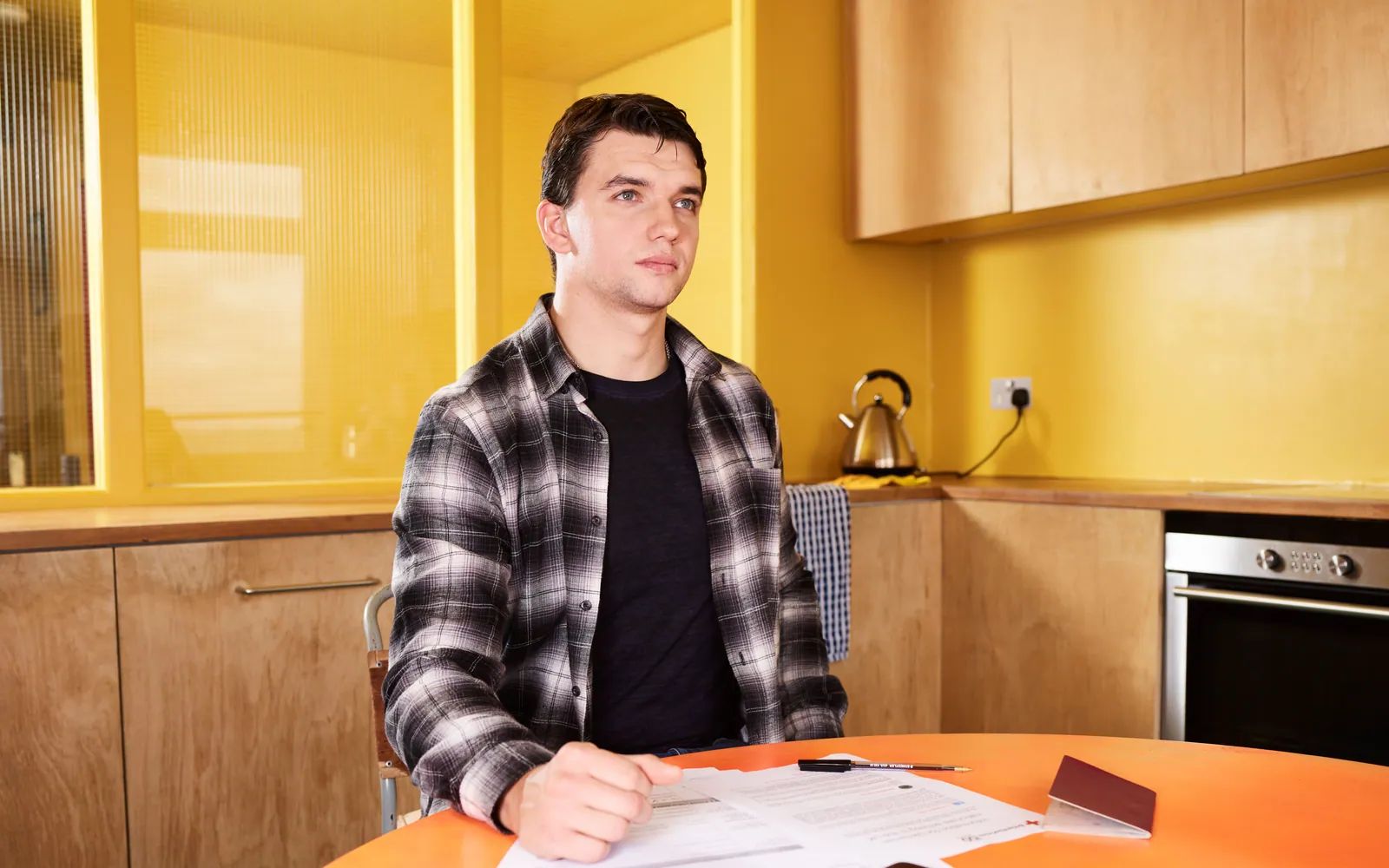 Person reviewing savings at a kitchen table