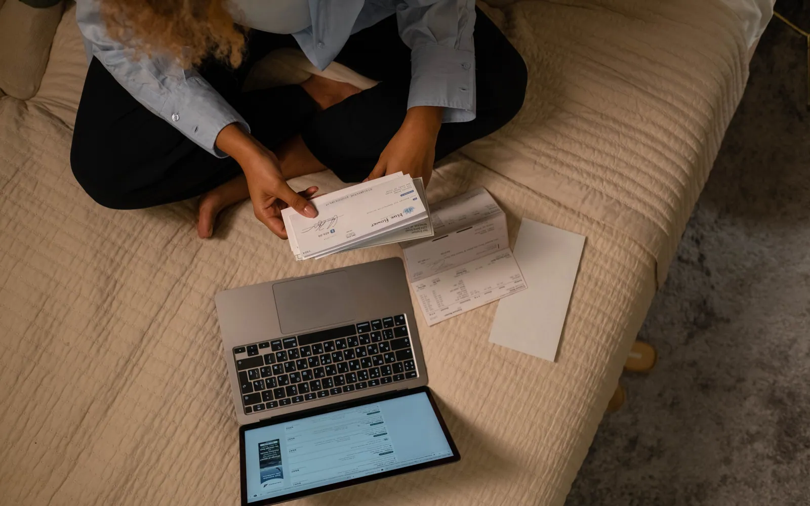 Person managing savings on a laptop at home
