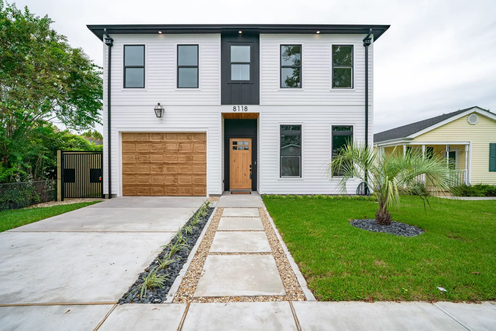 Modern two-story home in a New Orleans neighborhood, front elevation on a sunny day