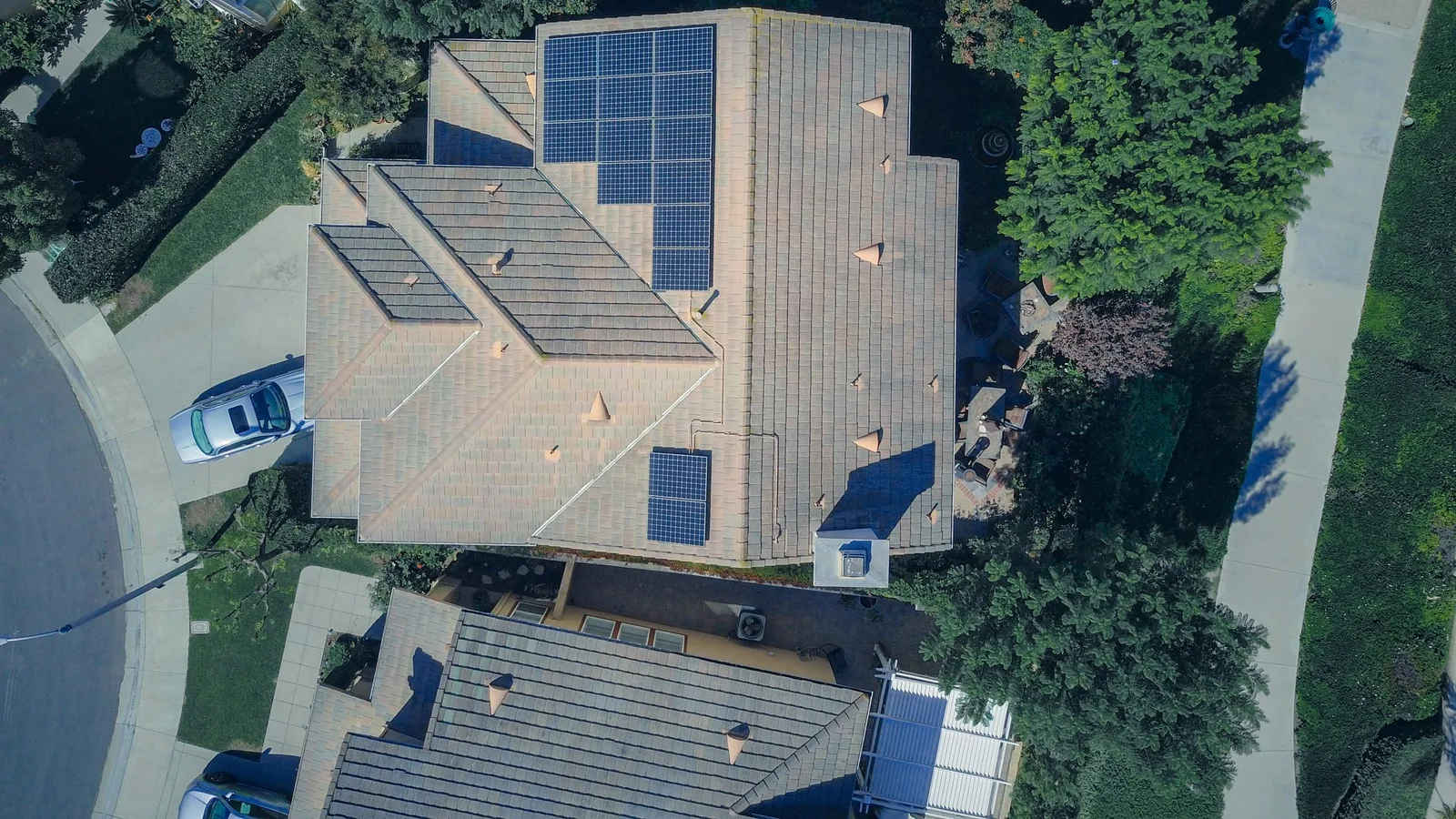 Overhead view of a suburban home with solar panels across its roof