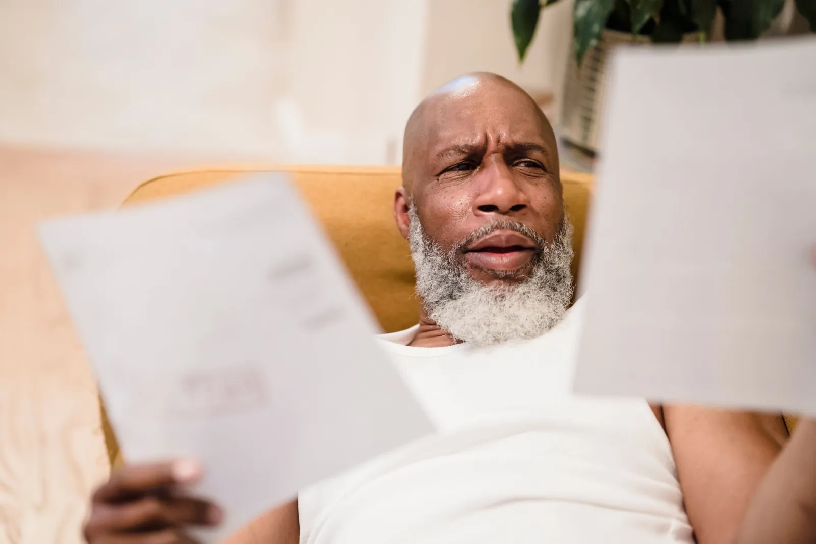 A person sitting at a table reading through printed policy documents