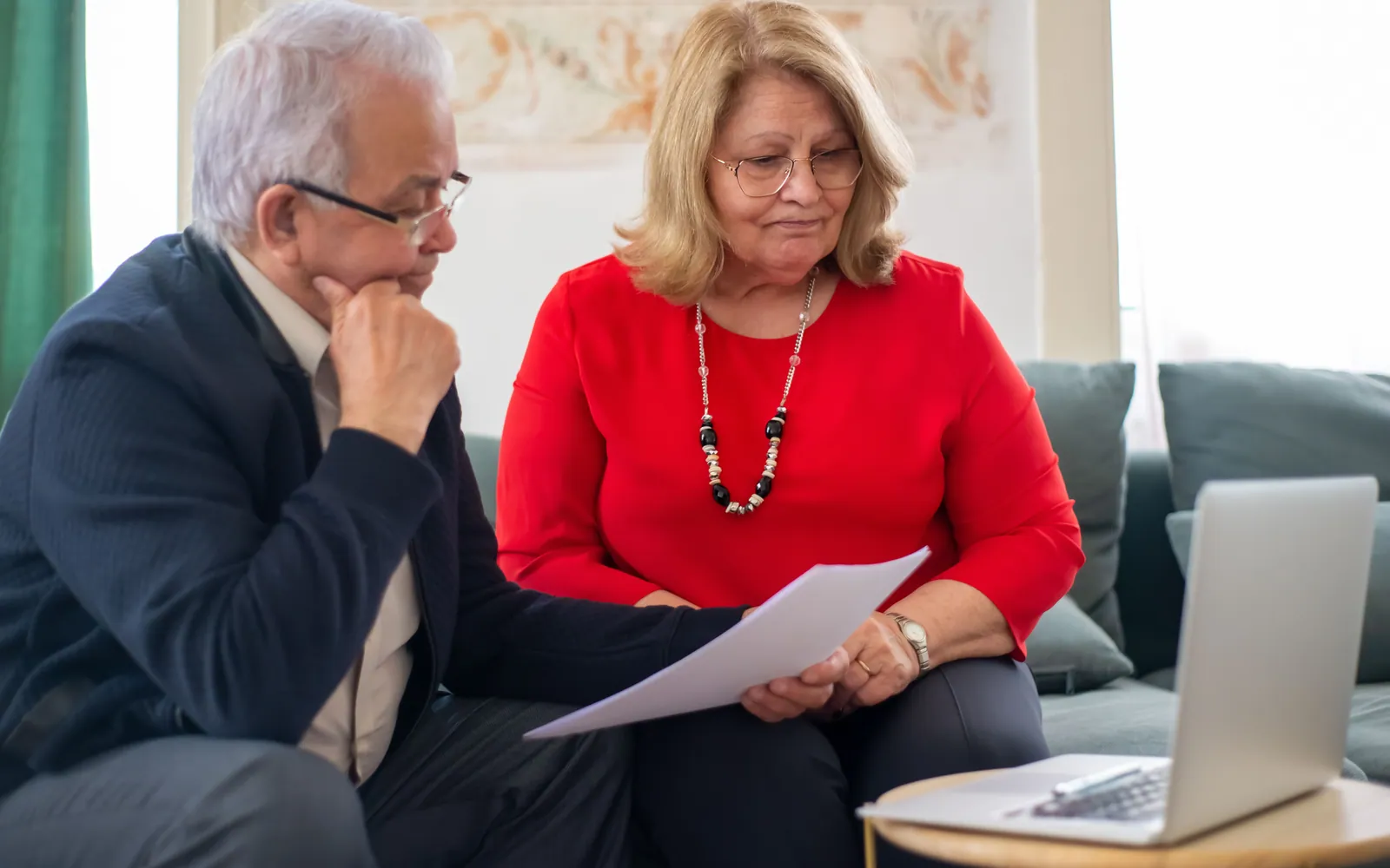 Retired couple reviewing finances at home