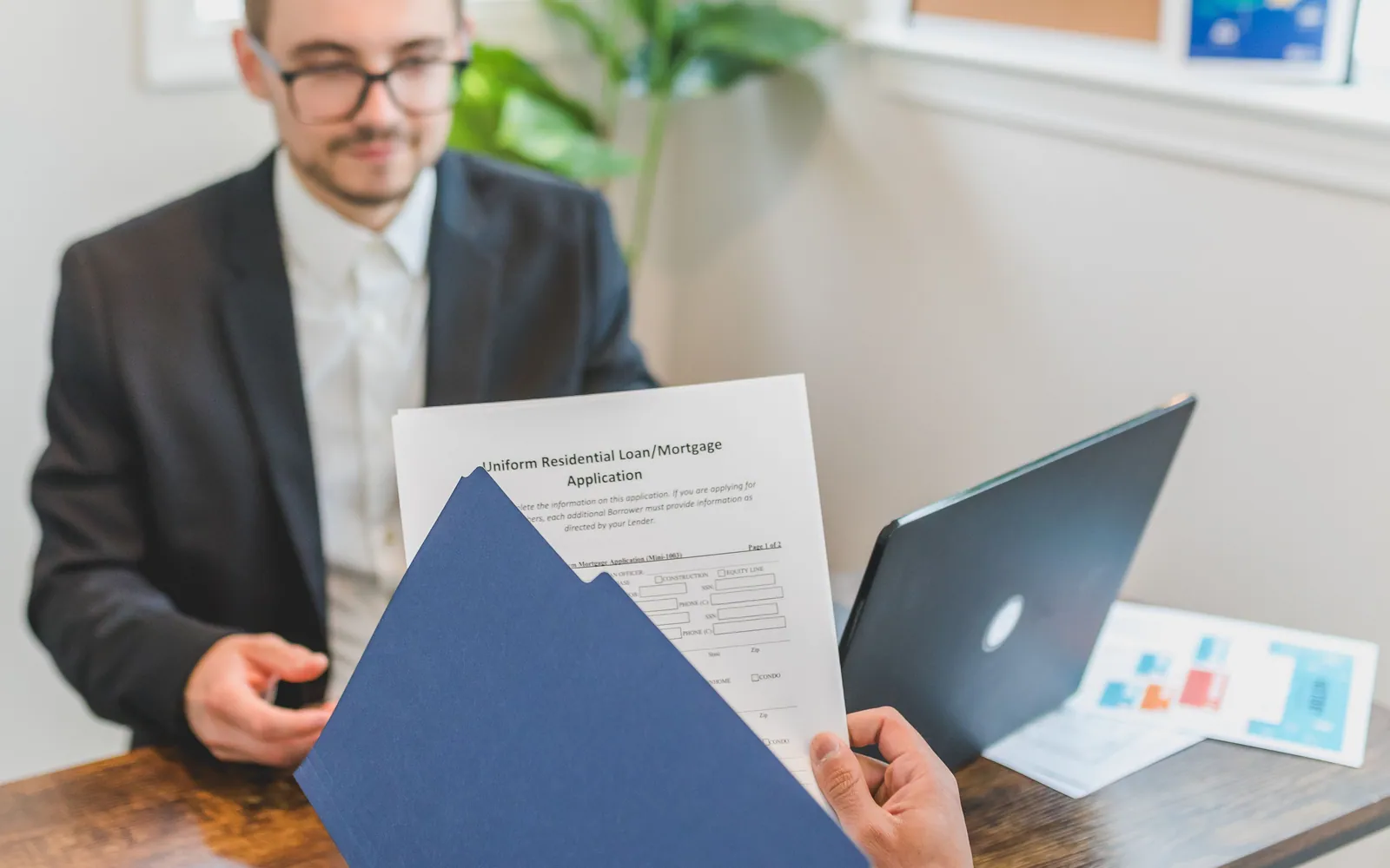 Couple reviewing loan documents with an advisor
