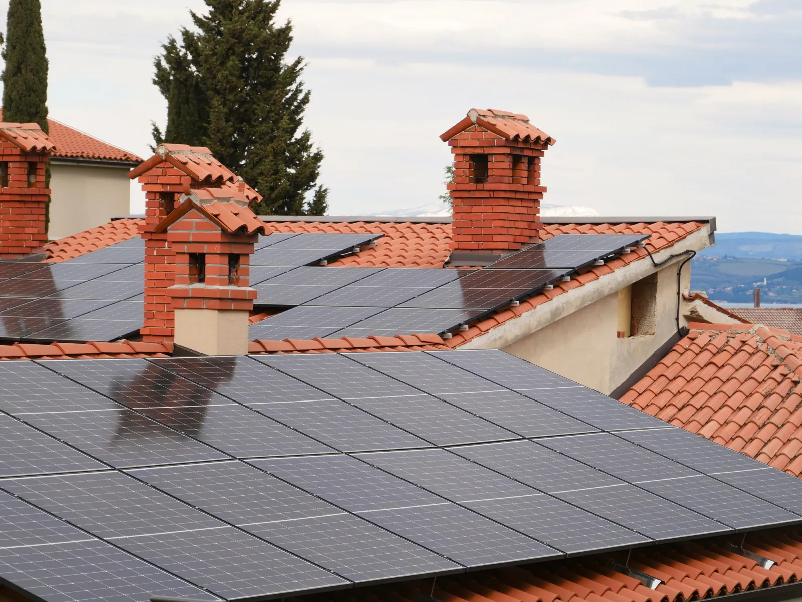 Solar panels installed on tiled roofs across a residential neighborhood