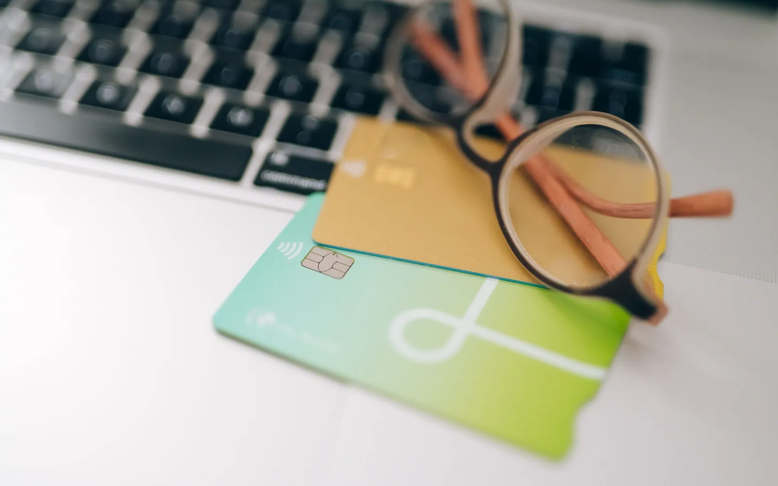 Two credit cards stacked on a desk