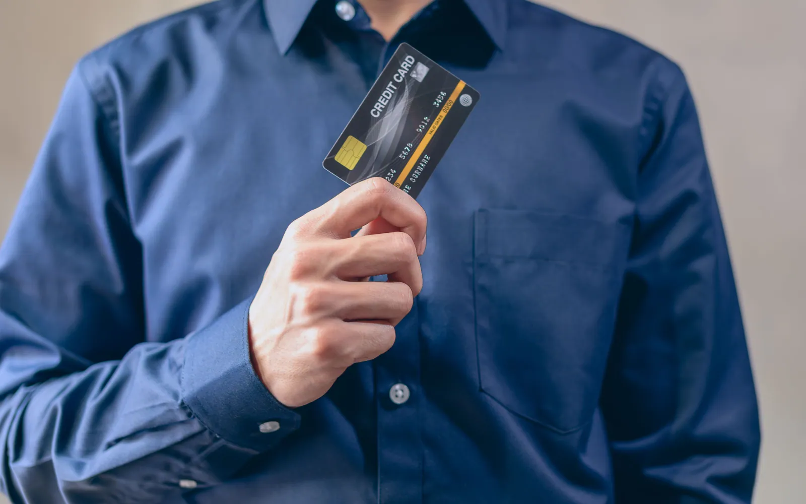 Person holding a single credit card