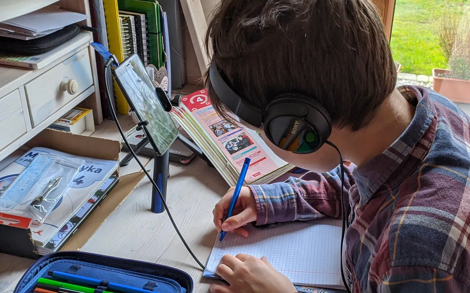 Student attending an online class at home