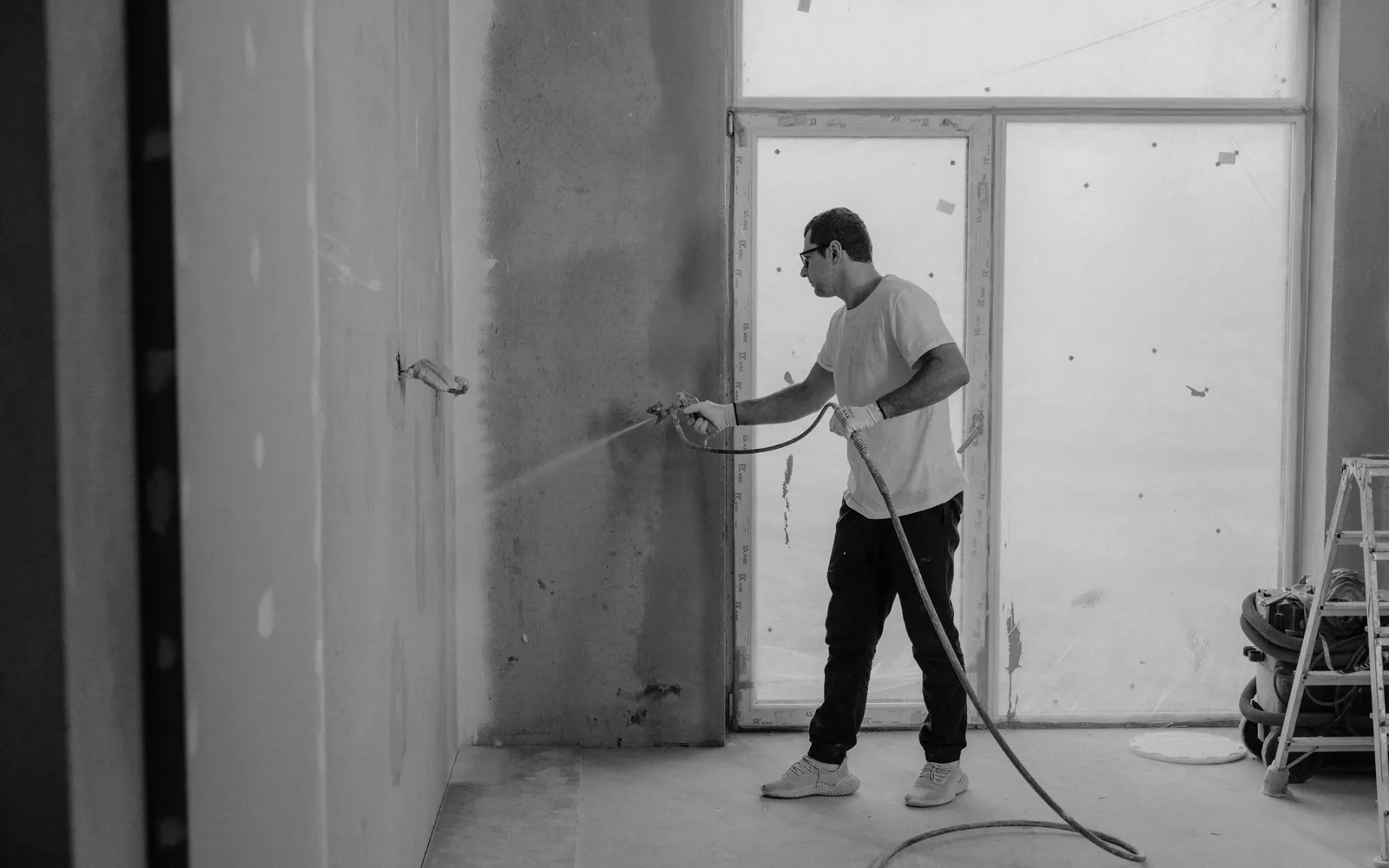 Person painting a room during a renovation