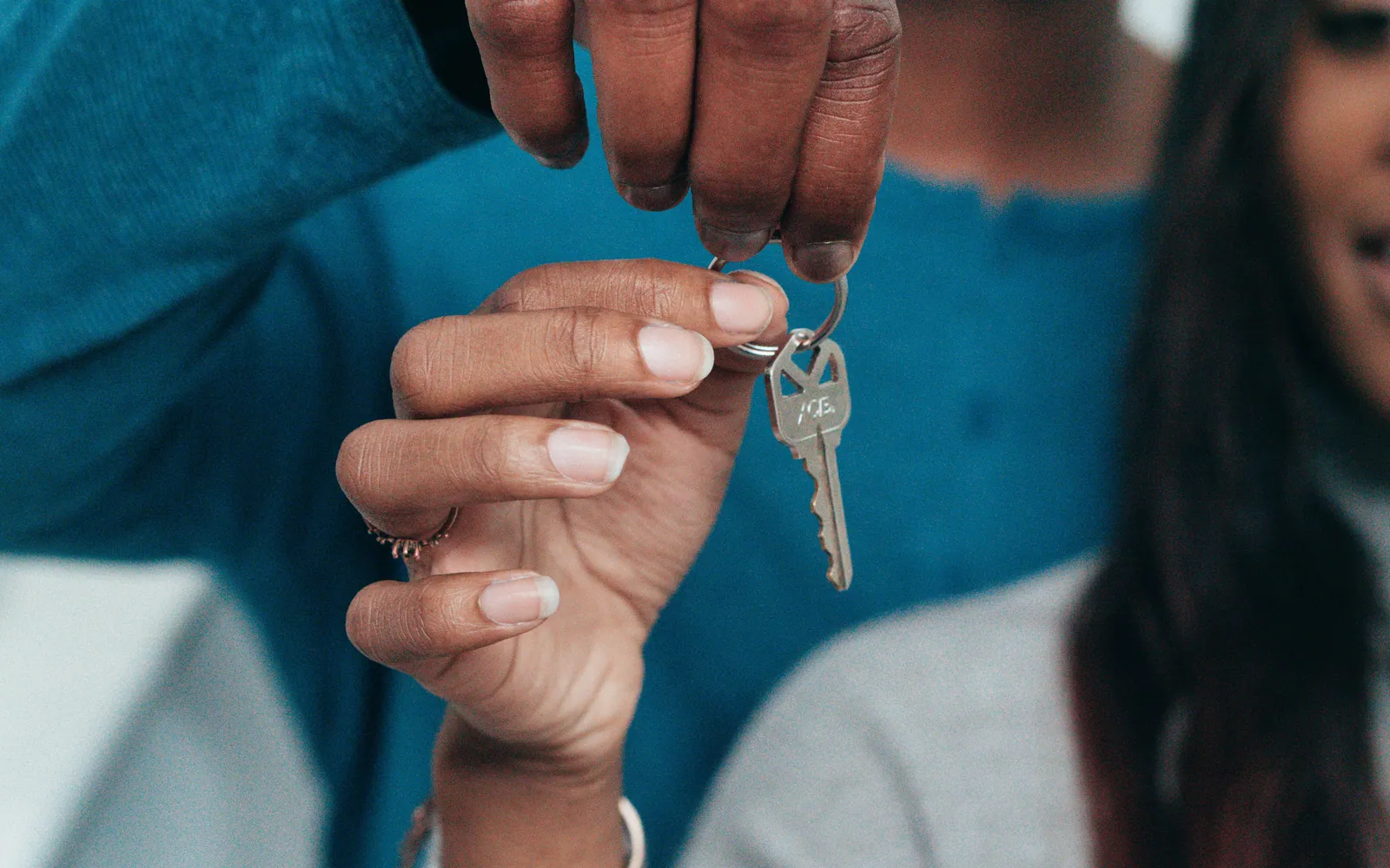 Young couple holding keys outside their home