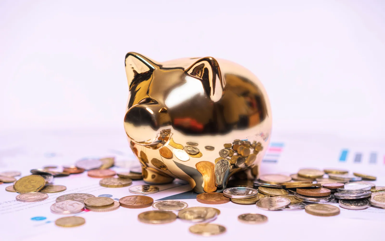 Piggy bank with coins on a desk
