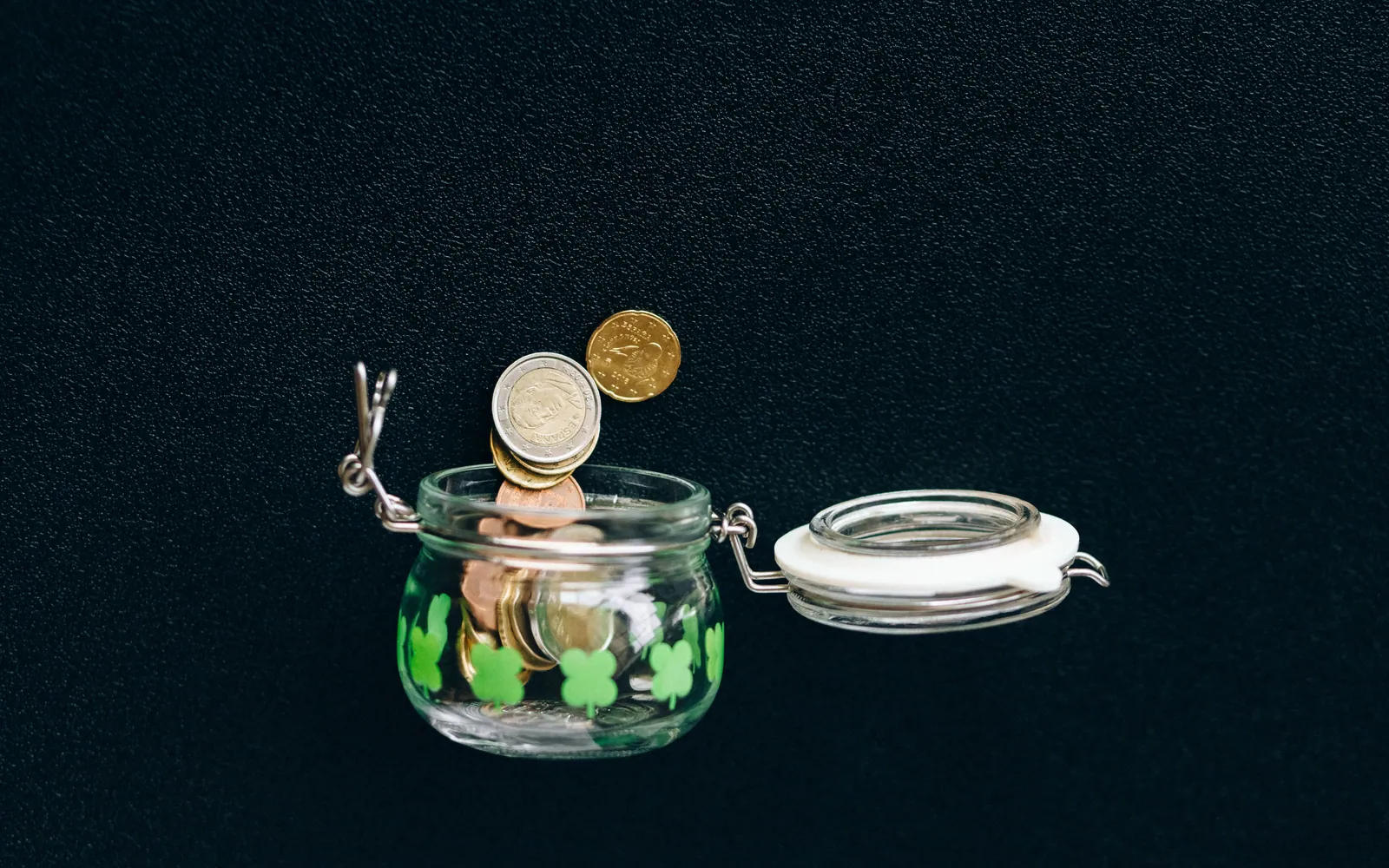 A glass jar full of coins