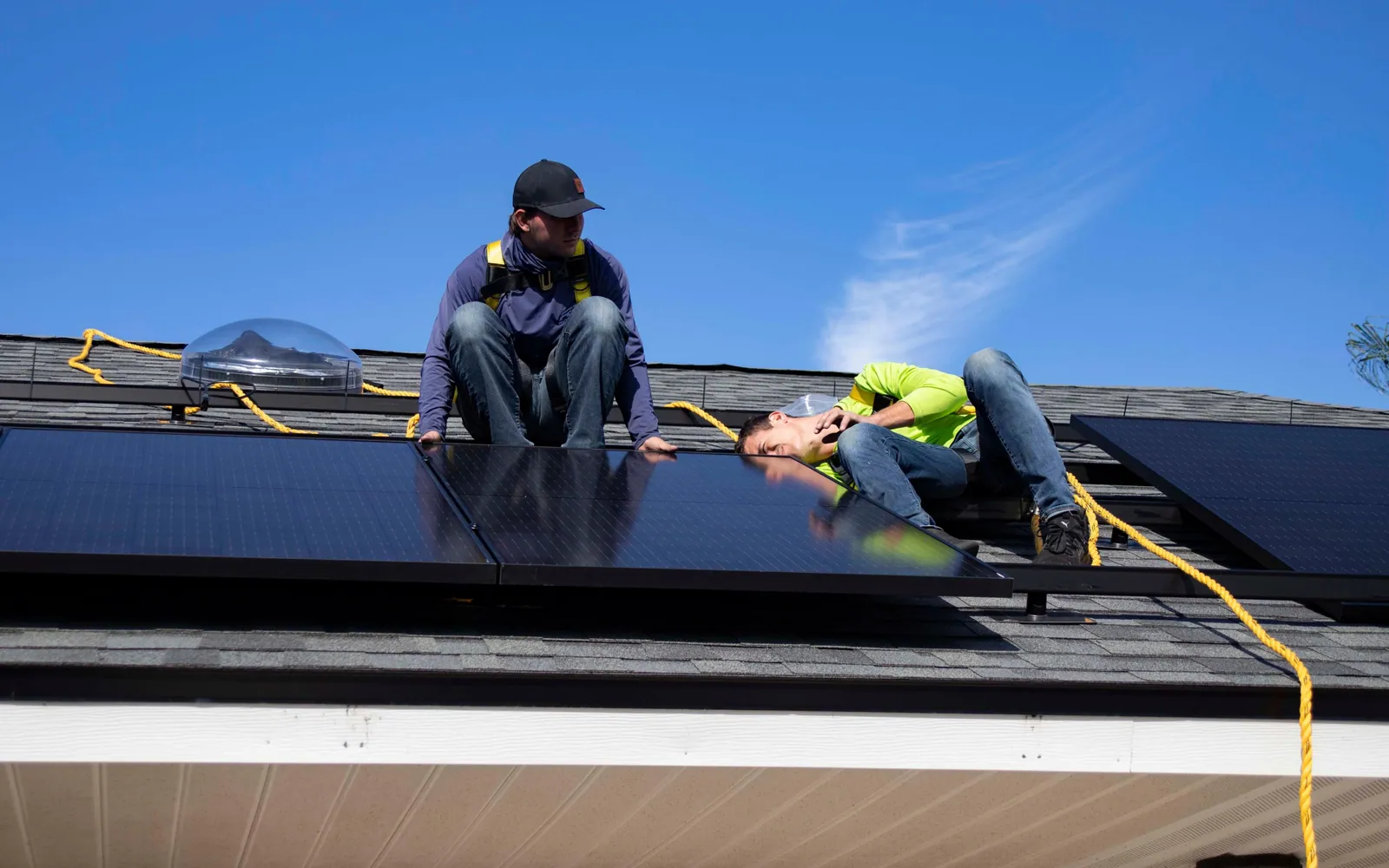 Solar installers working on a roof