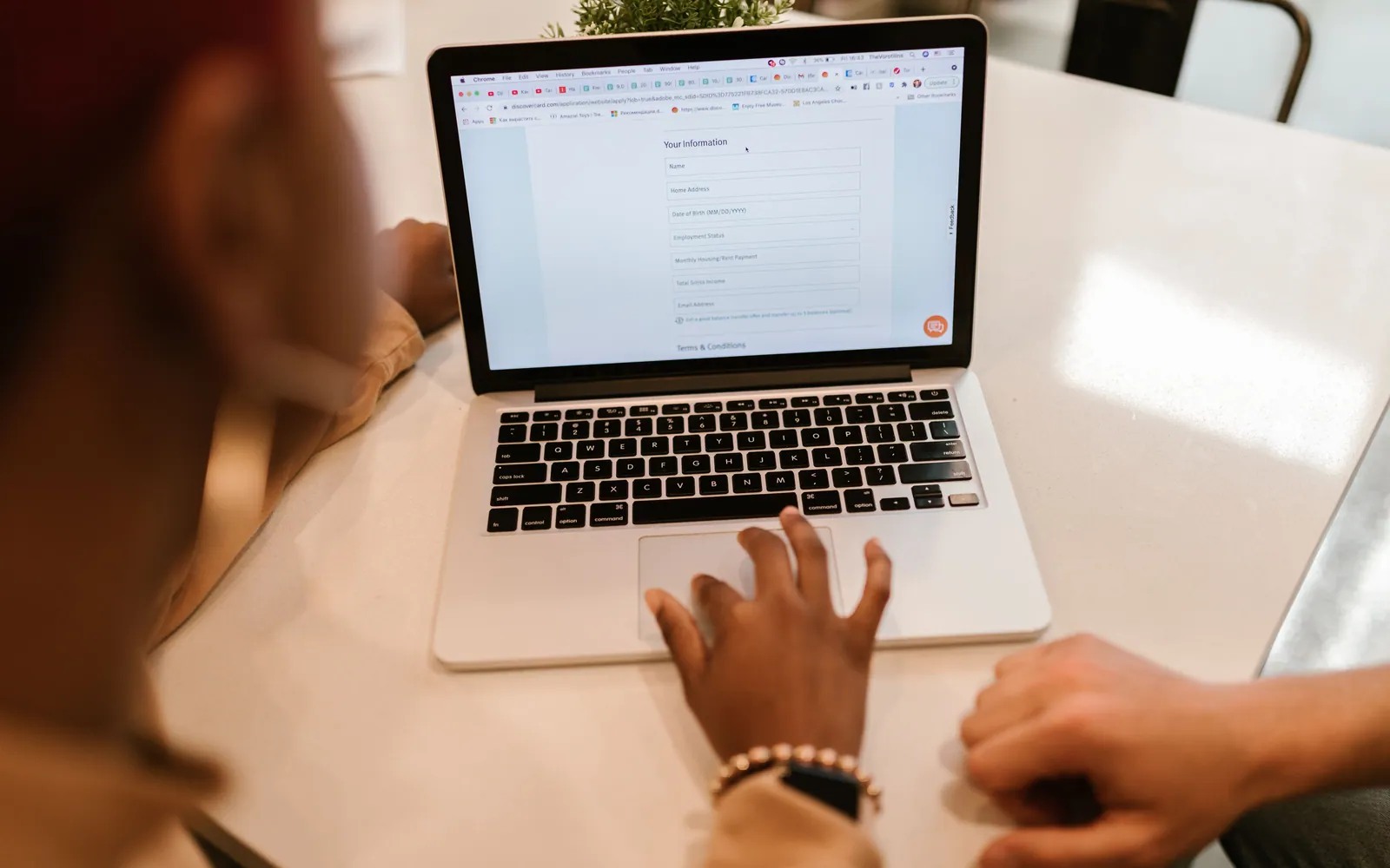 Student completing an application on a laptop