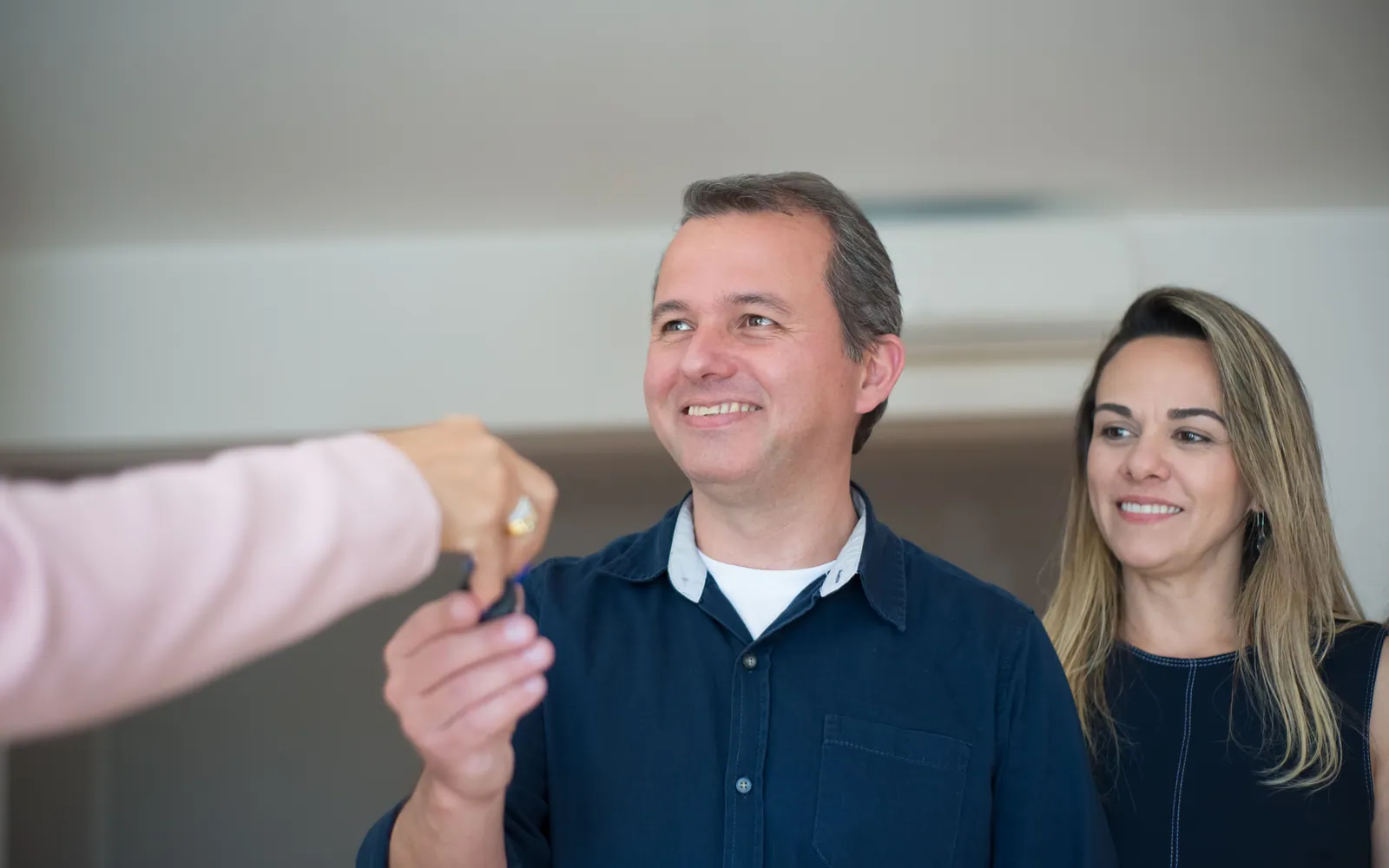 Young couple receiving the keys to a home
