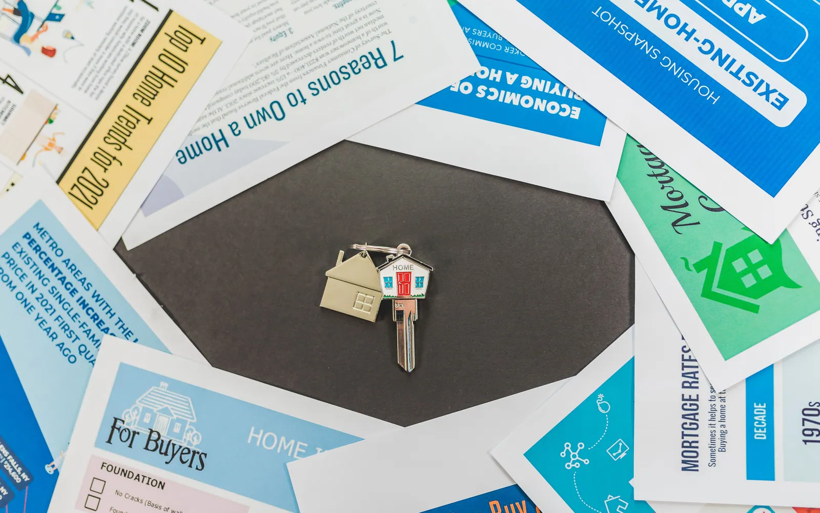 House keys on a table with documents