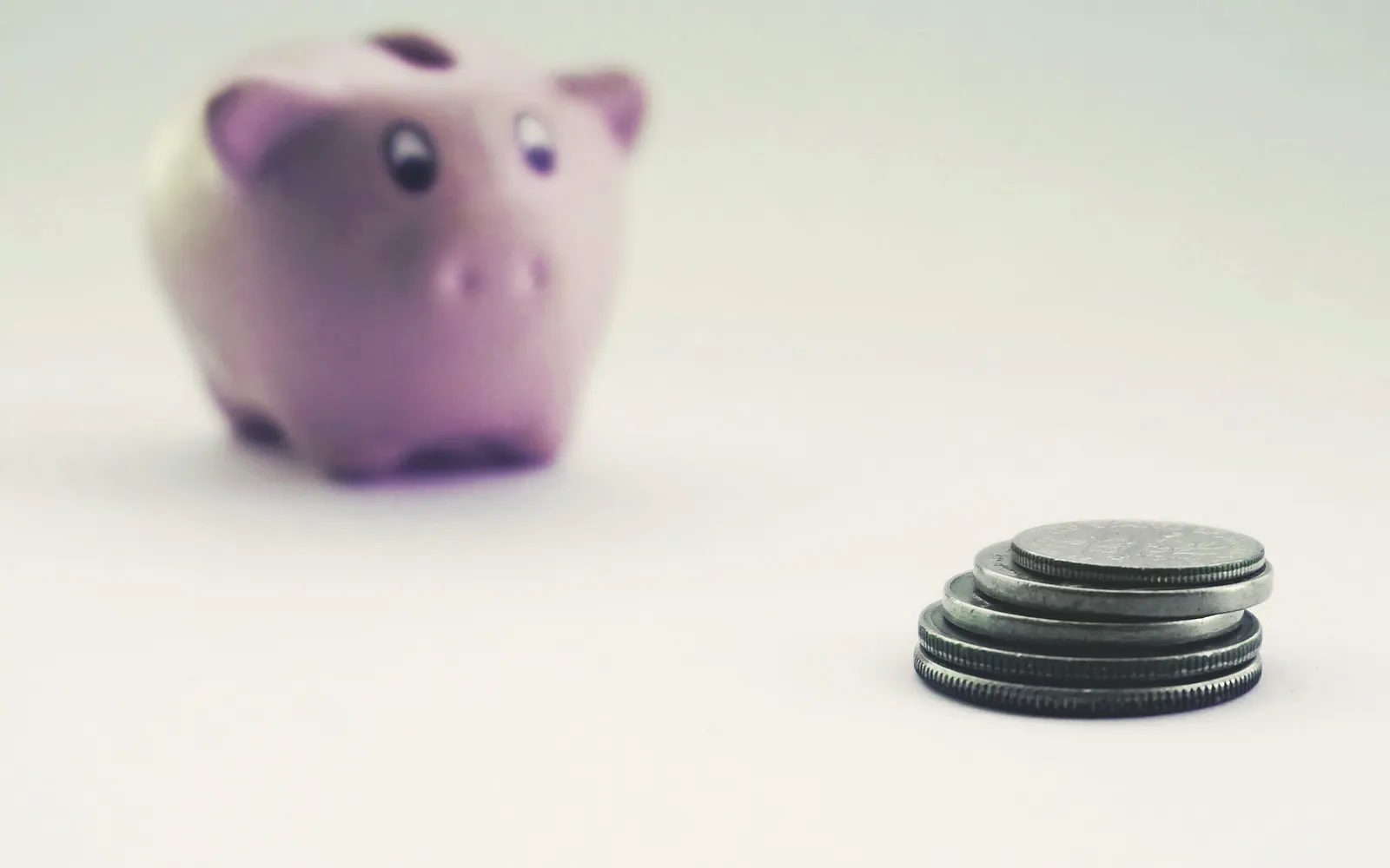Piggy bank beside stacked coins