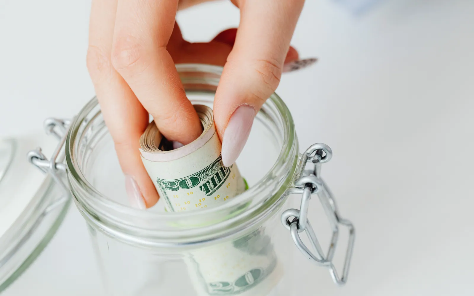 Glass jar holding cash savings