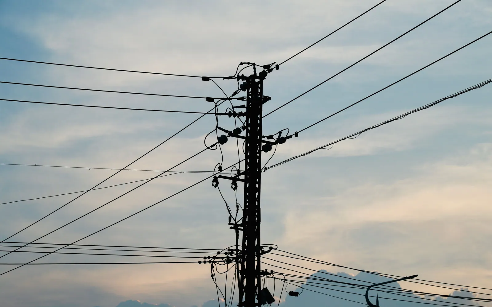 Power lines and electricity pylons against the sky