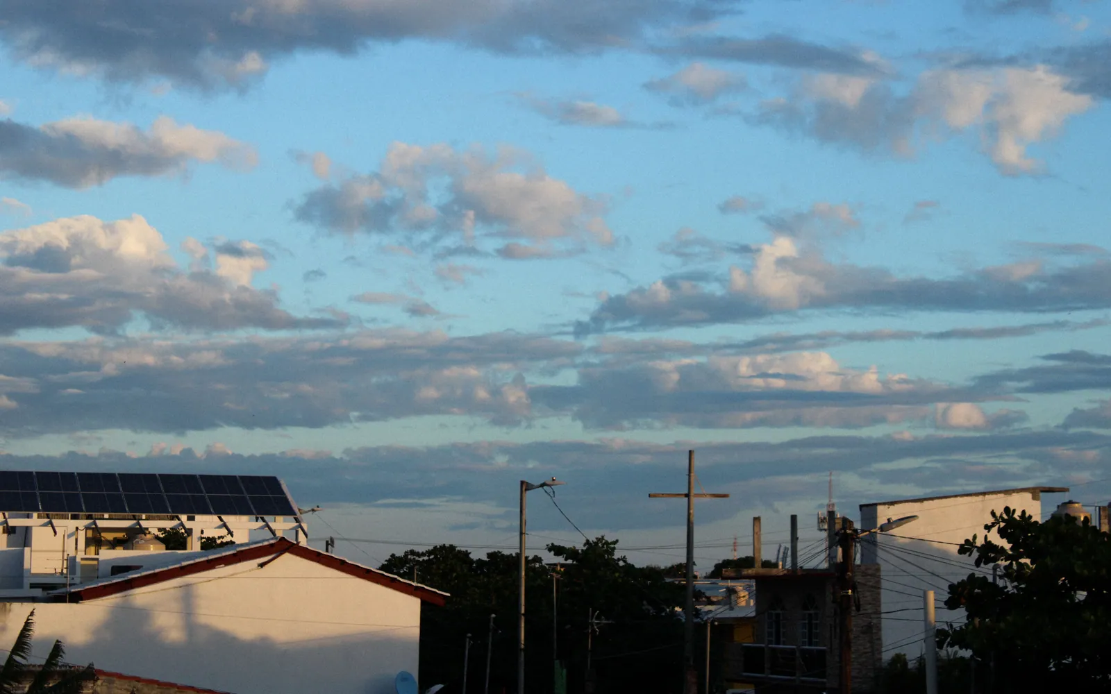 Rooftop solar panels against a blue sky
