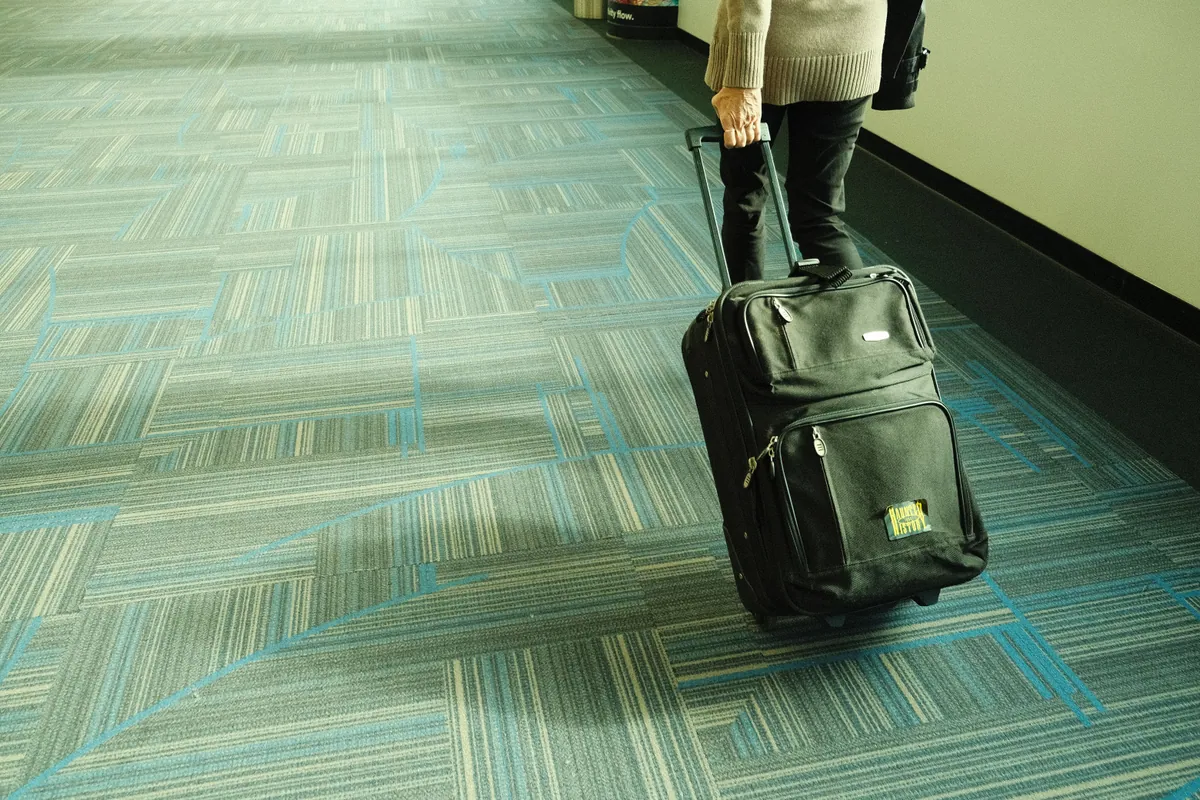 Traveler with a rolling suitcase at the airport