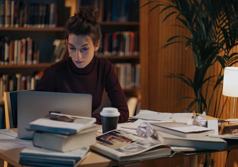 Person studying at desk with laptop