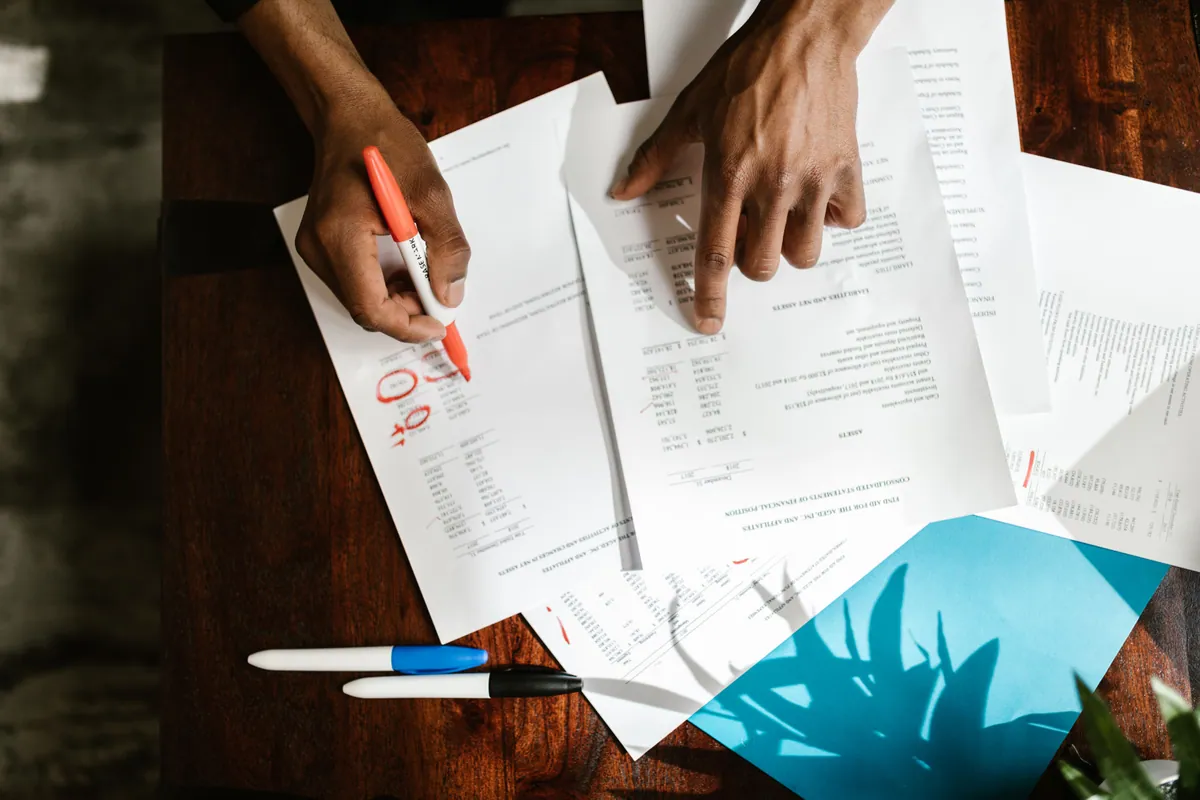 Person reviewing financial paperwork at desk